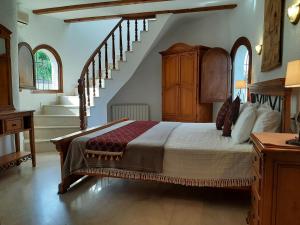 a bedroom with a bed with a staircase in it at Villa Limon - Tropical Oasis with Private Pool in Jávea