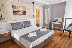 a bedroom with a large bed and a chair at Galata Door Hotel in Istanbul