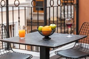 a table with a bowl of fruit and a glass of wine at Galata Door Hotel in Istanbul