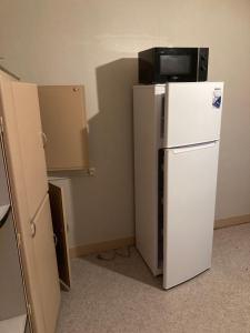 a white refrigerator with a television on top of it at MON DADA in Granville +4 photos