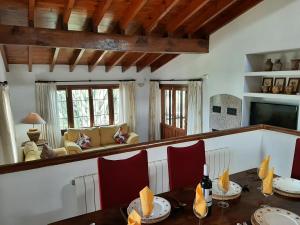 a dining room with a table and red chairs at Villa Limon - Tropical Oasis with Private Pool in Jávea