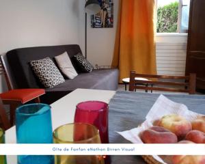 a living room with a table with a bowl of fruit at Gîte de Fanfan in Barèges