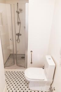 a white bathroom with a shower and a toilet at Galata Door Hotel in Istanbul +69 photos
