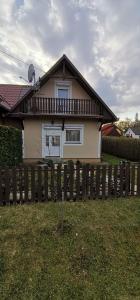 a house with a fence in front of it at Kotnyek nyaraló in Balatonkeresztúr