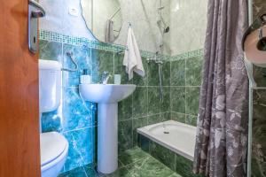 a bathroom with a sink and a toilet and a shower at Apartments Leona in Neum