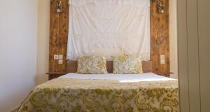 a bedroom with a bed with a curtain above it at Athor Villa in Sitia