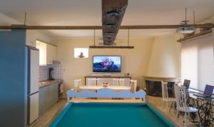 a living room with a pool table and a tv at Athor Villa in Sitia