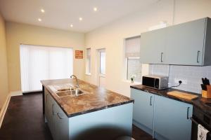 a kitchen with a sink and a counter top at The Retreat in Blackpool
