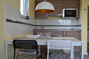 a kitchen with a table with two wine glasses on it at Loft Apartments Pulheim in Pulheim