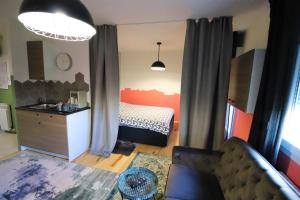 a room with a bedroom with a bed and a couch at Room Emma,between bus and train station,Netflix,speed Wi-Fi in Zagreb