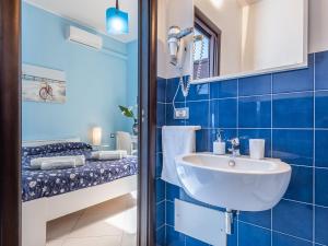 a bathroom with a sink and a bed at Thanit Rooms in Cagliari