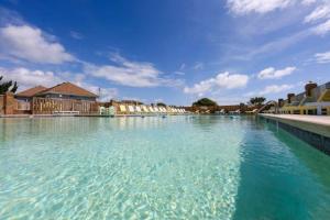 a large pool of blue water with buildings in the background at The Wright Place in Kitty Hawk