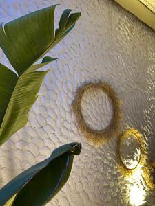a letter o on a table next to a plant at Aliko Hotel in Alaçatı