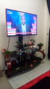 a flat screen tv sitting on top of a table at Chez Jamila in Dakar