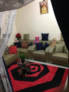 a living room with a couch and a red carpet at Chez Jamila in Dakar