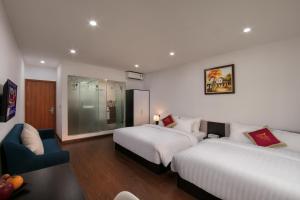 Postel nebo postele na pokoji v ubytování Hanoi Aria Central Hotel & Spa