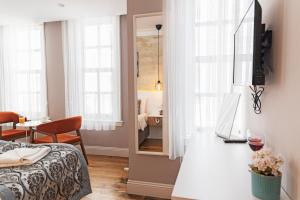 a room with a bed and a mirror and a table at Galata Door Hotel in Istanbul