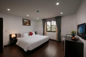 Postel nebo postele na pokoji v ubytování Hanoi Aria Central Hotel & Spa