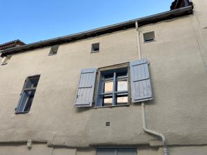 a building with blue shuttered windows on it at Le celebrity in Agen