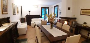 a living room with a dining table and a fireplace at La Torre di Longara in Calderara di Reno