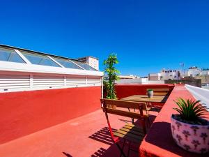 a balcony with a bench and a table on a roof at Alma Canaria Apartments & Rooms in Las Palmas de Gran Canaria