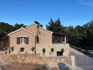 a house with a stone wall at Tara house in Zavala