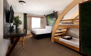 a hotel room with two bunk beds and a desk at Natura Treescape Resort in Wisconsin Dells +77 photos