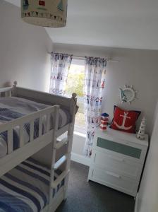 a bedroom with a bunk bed and a window at Seahouses cottage in Seahouses