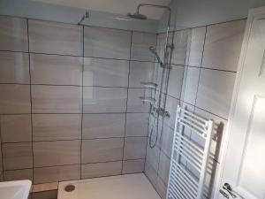 a bathroom with a shower and a toilet at Seahouses cottage in Seahouses