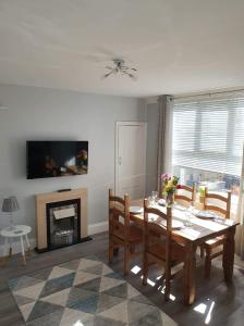 a dining room with a table and a fireplace at Seahouses cottage in Seahouses