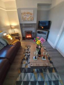 a living room with a couch and a fireplace at Seahouses cottage in Seahouses