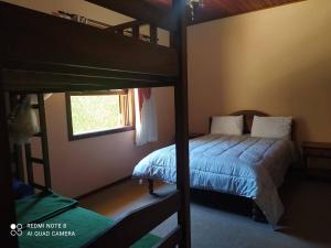 - une chambre avec 2 lits superposés et une fenêtre dans l'établissement Pequeno Paraiso, à Campos do Jordão