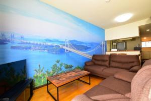 a living room with a mural of a bridge at Maison Ota Building A Building B - Vacation STAY 11140 in Takamatsu
