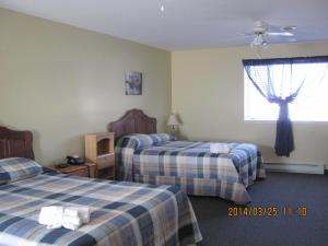 Voodi või voodid majutusasutuse Motel Parc Beaumont Inc. toas