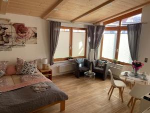 a bedroom with a bed and a table and chairs at Ferienhaus Elisabeth in Füssen