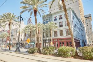 a city street with palm trees and buildings at Sonder at The Vitascope in New Orleans