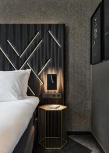 a hotel room with a bed and a nightstand next to a bed sidx sidx at Le Marin Boutique Hotel in Rotterdam