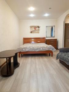 a bedroom with a bed and a table at проспект металлургов 9 in Kryvyi Rih