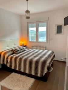 Ένα ή περισσότερα κρεβάτια σε δωμάτιο στο Alojamientos con encanto Ruliña