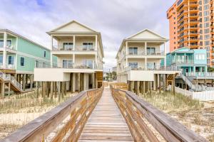 a wooden boardwalk leading to houses on the beach at Beach Vista Two in Orange Beach