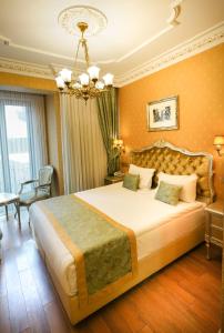 a bedroom with a large bed and a chandelier at Hotel Gritti Pera & Spa in Istanbul