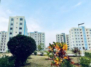 a group of tall white buildings in a park at Apex Mbweni Apartment in Kiembi Samaki