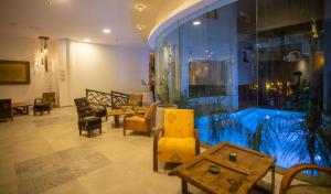 a lobby with chairs and tables and a large window at Dellarosa Boutique Hotel and Spa in Marrakesh