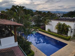 a view of a swimming pool from a house at Hotel Boutique Villa Casuarinas in Cali