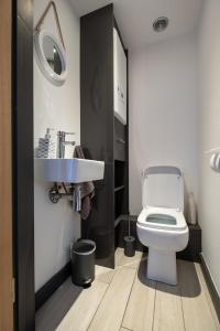 a bathroom with a white toilet and a sink at Central Penzance, Modern stylish home, Near Seafront with Gated parking in Penzance