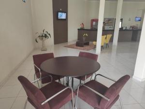 a dining room with a table and chairs at Vitalliti Hotel in Alta Floresta