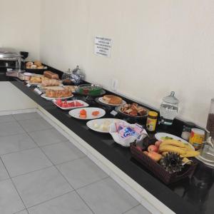 a buffet line with many different types of food at Vitalliti Hotel in Alta Floresta