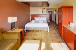 a hotel room with a bed and a couch at Canad Inns Destination Center Grand Forks in Grand Forks +39 photos