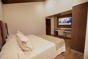 Postel nebo postele na pokoji v ubytování Hotel Sirari By Regina