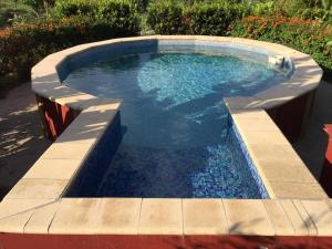 a swimming pool in a garden with a pool at Oasi Bochini in Avola